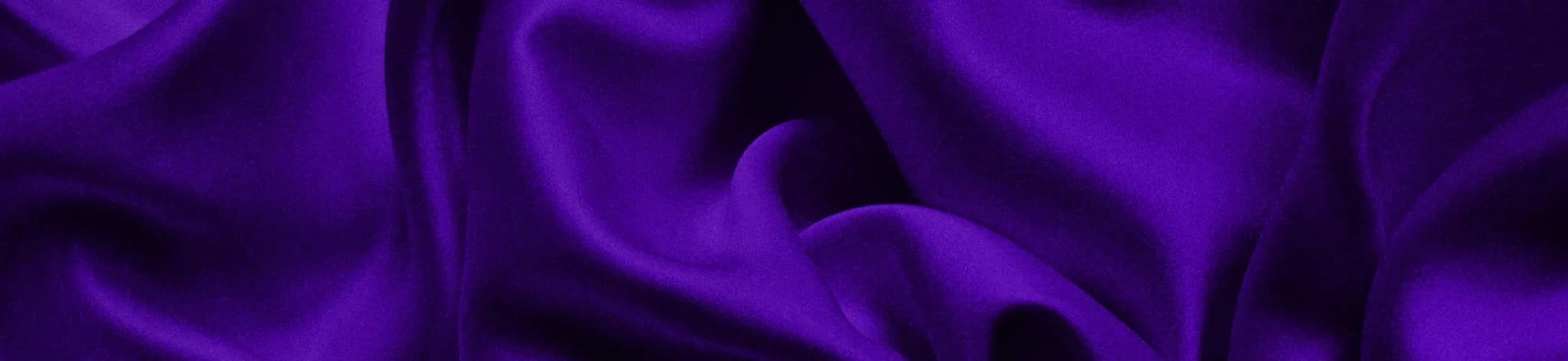 Soft folds of vibrant purple silk fabric